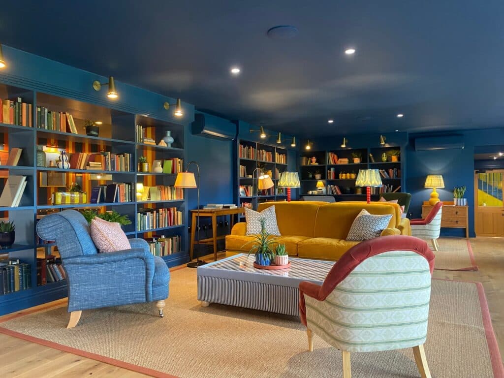 The lounge at Mad Swans, lined with bookshelves